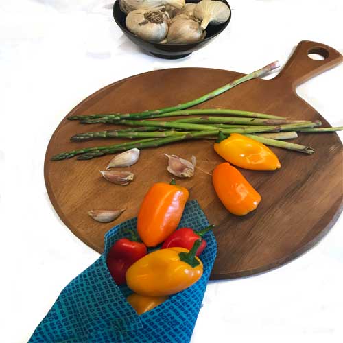 Small colored peppers and blue beeswax food wrap